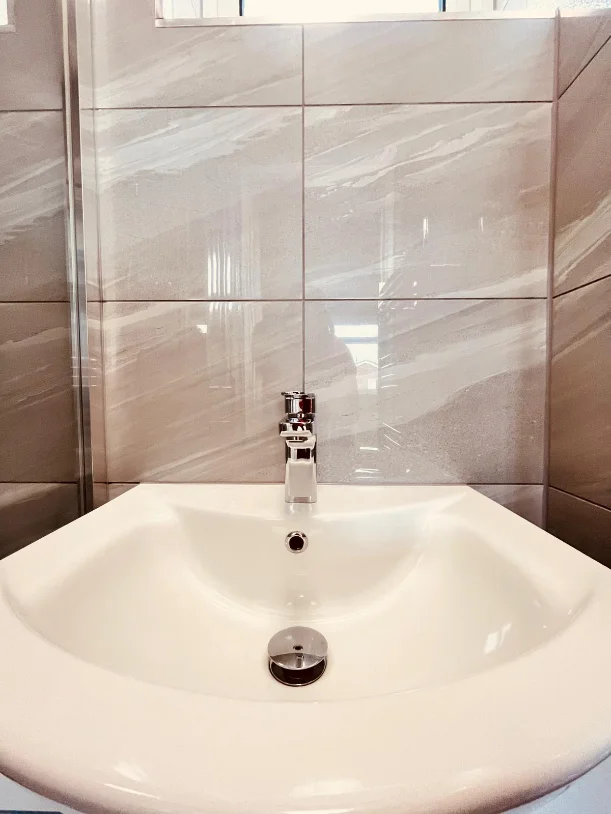 A freshly cleaned bathroom sink and tiles